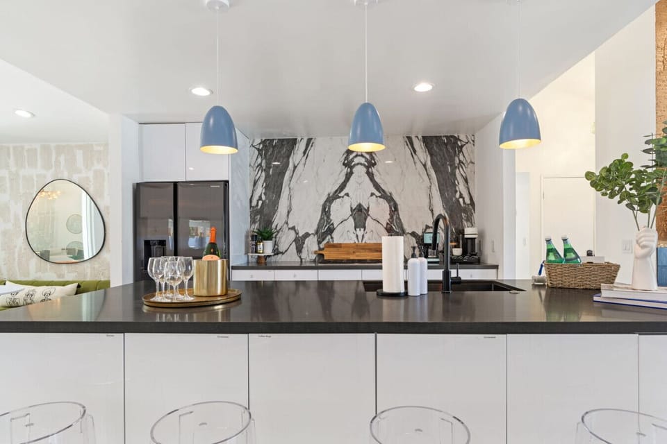 Chic dining space w/ statement lighting, warm tones, and an inviting setup for group dinners.