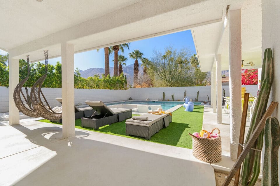 Shaded outdoor lounge w/ cushioned seating, ideal for afternoon chats or evening wind-downs.