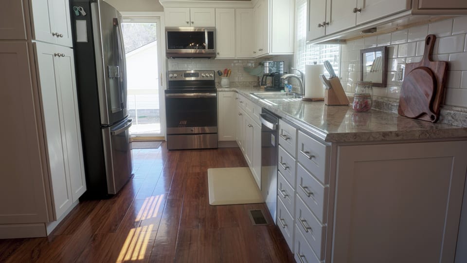 Fully stocked kitchen with modern appliances and conveniences.