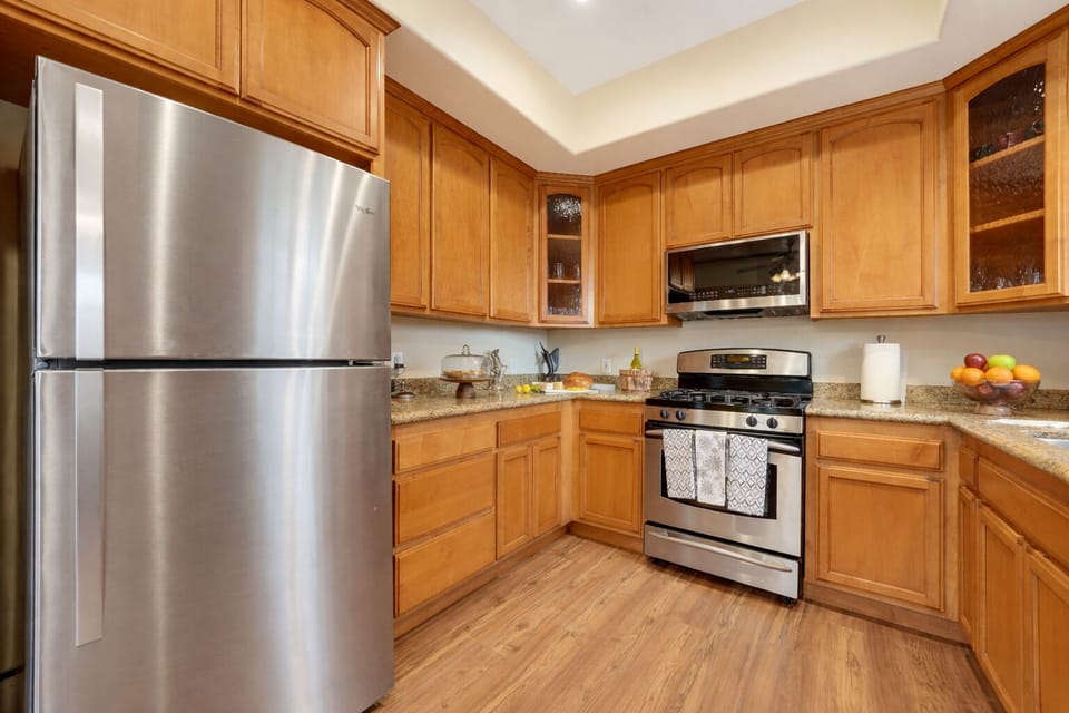 Spacious kitchen with full-size refrigerator and ample counter space.