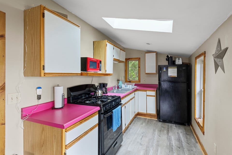 Dining Area - Charming kitchen with modern appliances and a cozy dining nook, perfect for enjoying a home-cooked meal. The spacious layout and vibrant colors make meal prep fun and inviting for any guest.