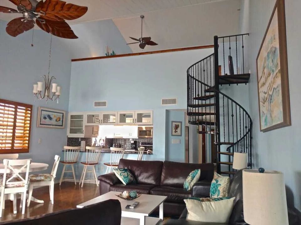 The spacious living room features soaring cathedral ceilings, a pullout queen memory foam sofa, and a second cozy sofa. Enjoy scenic views of the Intercoastal Waterway from the balcony, where you can watch dolphins, manatees, and boat traffic.