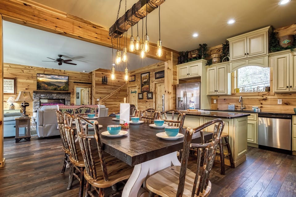 Smoky Mountain Vacation Rental “The Manor at Burg Hill” – Dining area, fully furnished kitchen, and living room.