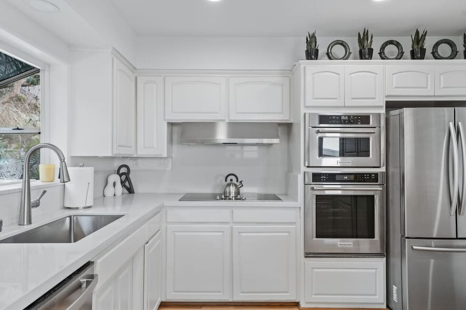 Bright full kitchen with counter stools