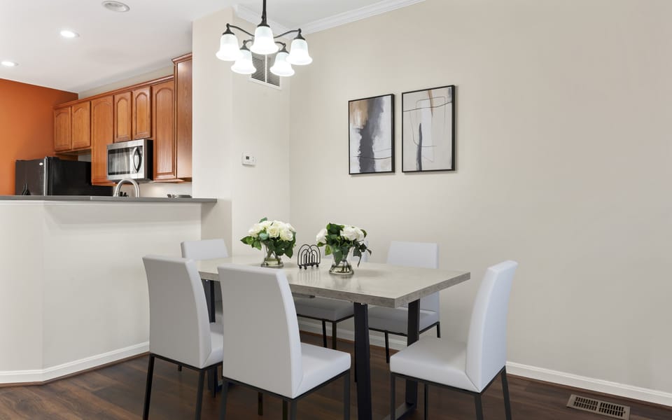 Dining table seats 6 comfortably, with hardwood floors for added charm.