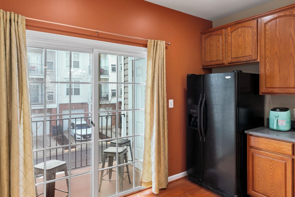 Fully stocked kitchen with appliances, airfryr, blender, and utensils, pots/pans