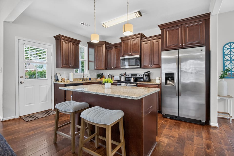Spacious gourmet kitchen with granite island and stainless appliances