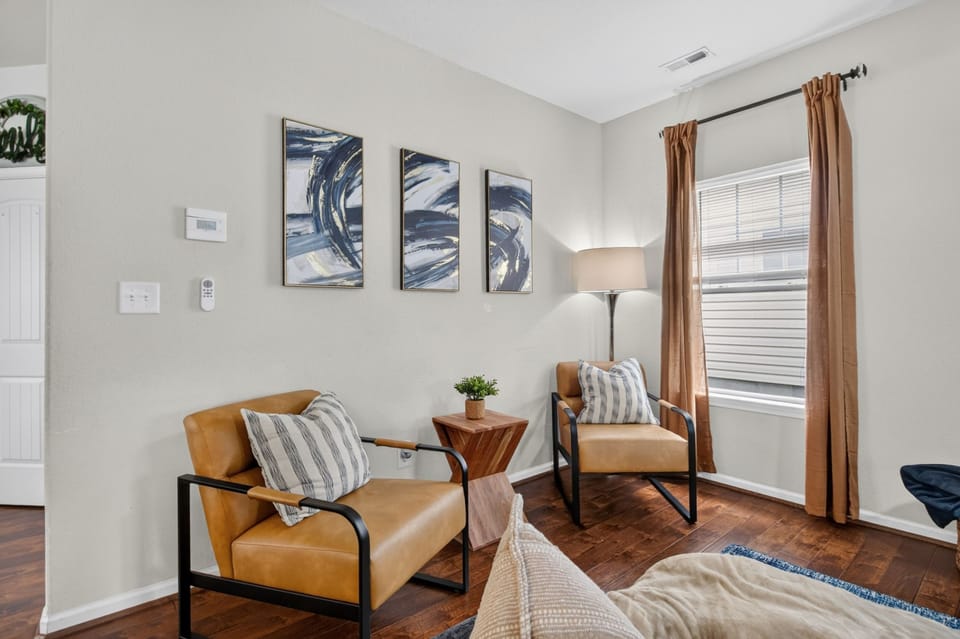 Cozy modern sitting nook with leather chairs and warm natural light