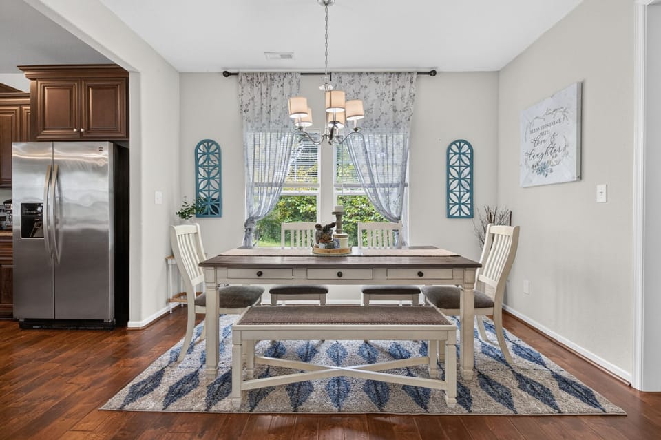 Bright farmhouse dining area with seating for six and sunny garden views