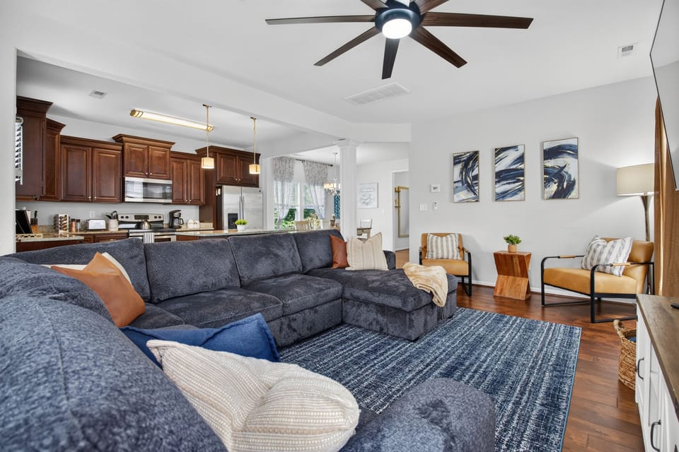 Spacious open living room with large sectional and stylish modern kitchen