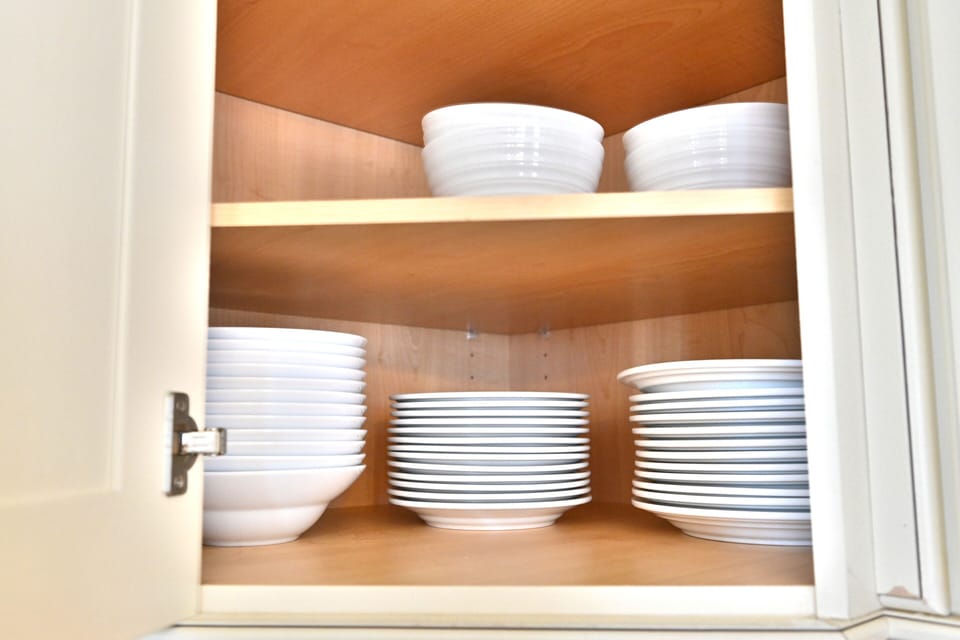 Kitchen shelves stocked with plates and dining essentials
