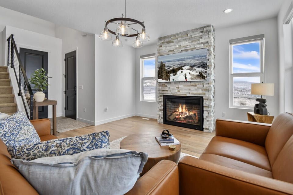 Living room on main floor off kitchen with fireplace, TV, and amazing views