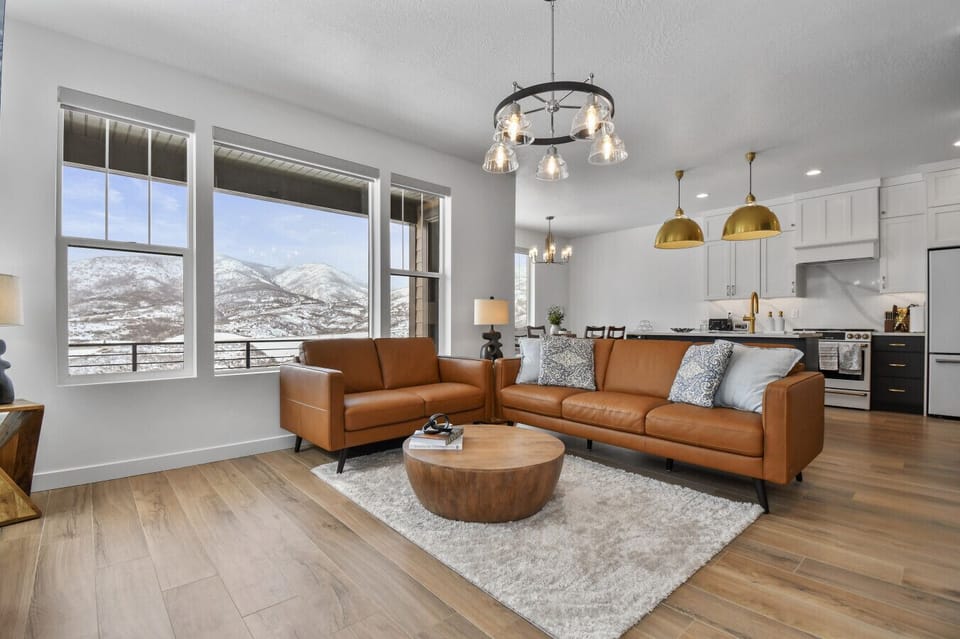 Living room on main floor off kitchen with fireplace, TV, and amazing views