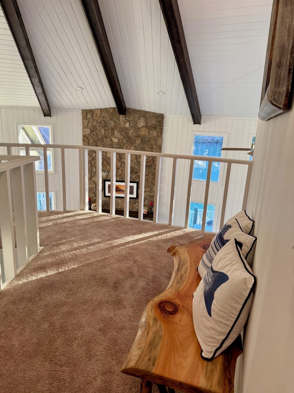 Upstairs landing area with views of living space and the lake just outside!