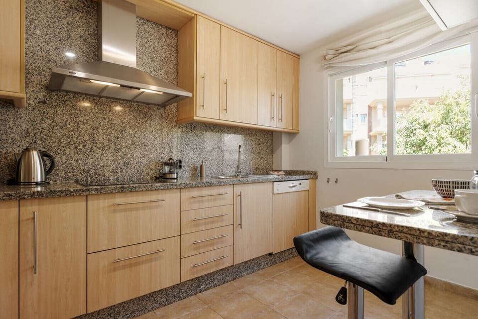 Fully-equipped kitchen with Nespresso coffee maker, oven, dishwasher, and washing machine