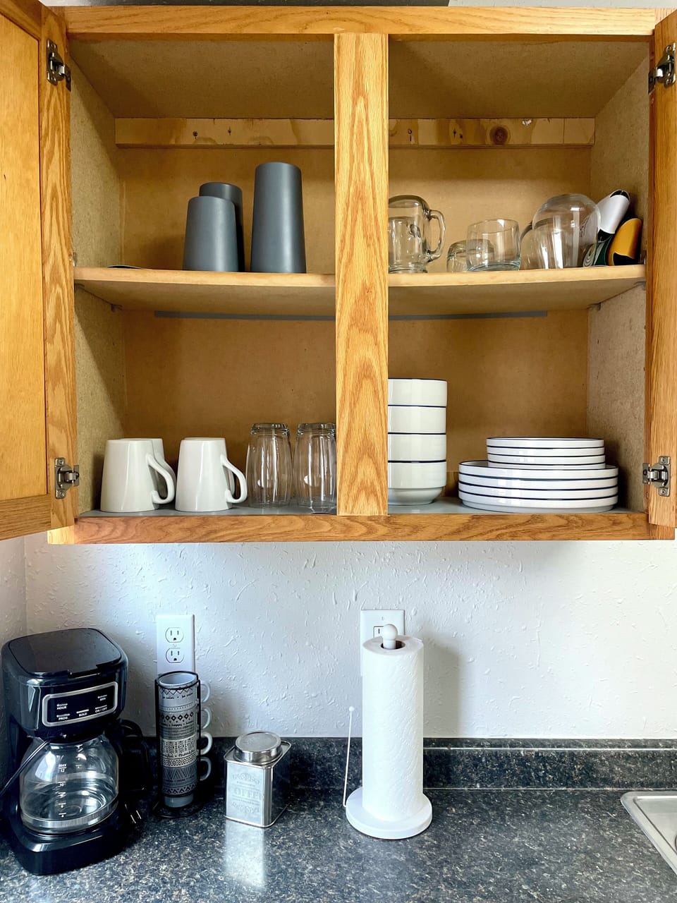 Place setting for 4, glassware, and coffee maker (with coffee!)