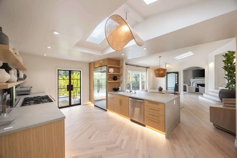 Expansive kitchen featuring a central island, high-end appliances, and skylit elegance.