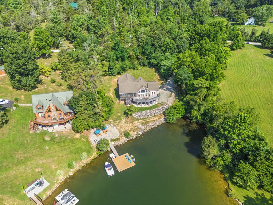 Aerial view of private retreat with dock and peaceful setting