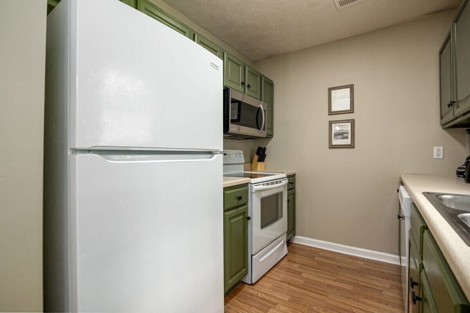 Whip up delicious meals in this stylish green-accented kitchen!