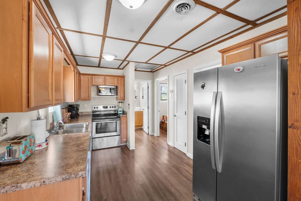 The fully equipped kitchen includes stainless steel appliances everything you need to make meals inside or enjoy takeout from any local restaurant.