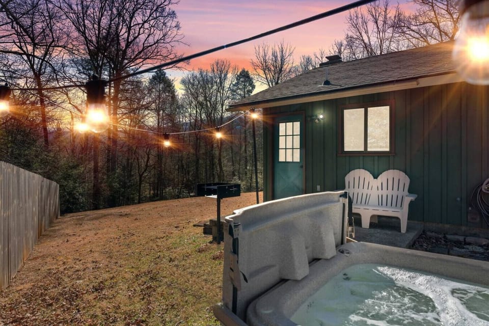 Relax in the bubbling hot tub overlooking the peaceful backyard.