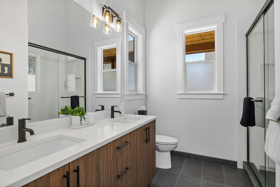 Second bedroom with en suite bathroom featuring a double vanity and walk in shower