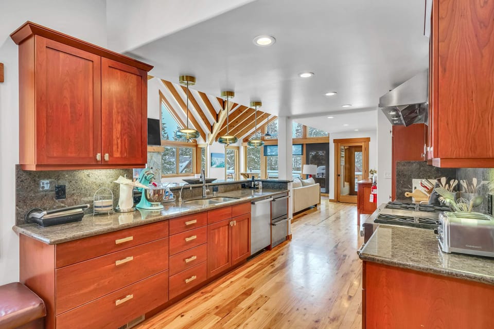 Kitchen: Drip coffee maker, Nespresso, Crockpot, blender, stand mixer, 2 sinks, food-warming drawers, 9-burner stove with griddle, double oven, sub-zero fridge, cooking utensils, tableware