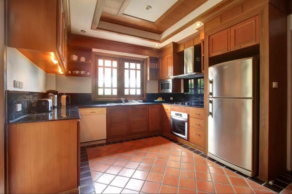 Kitchen, showing amenities, also has a utility cupboard with washing machine