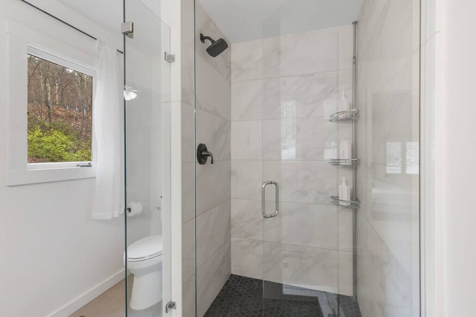 Full bathroom with shower, attached to bedroom #1. Located on the first floor of the house.