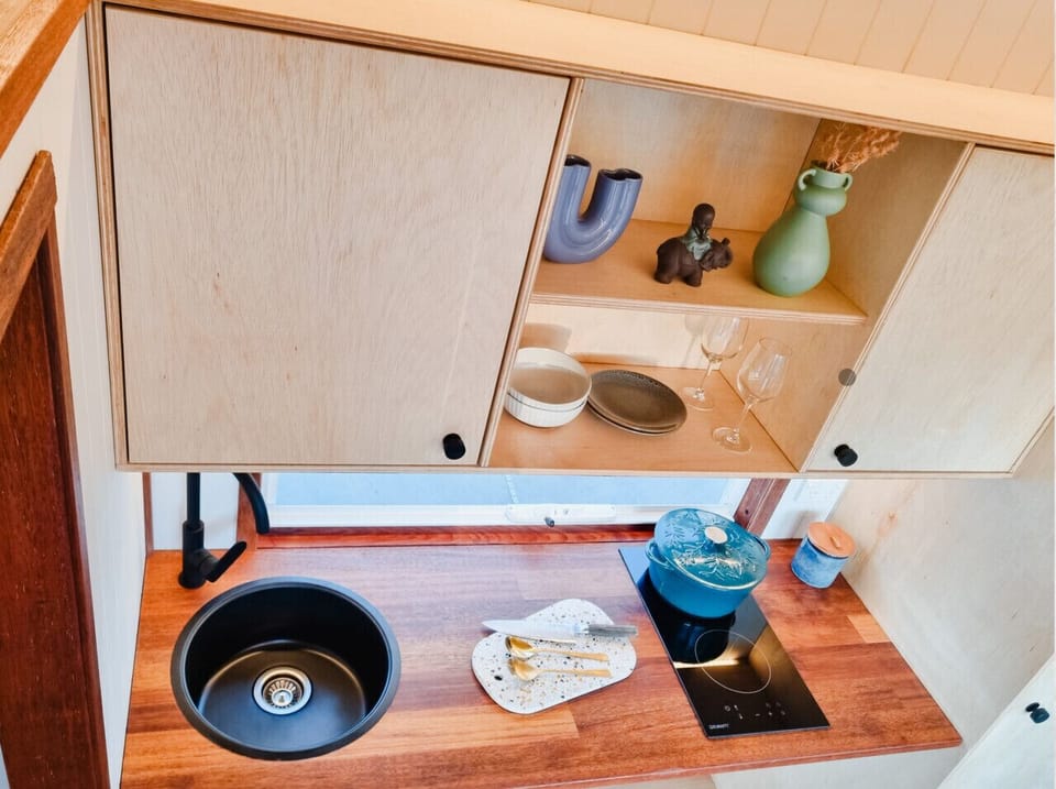 Kitchen with all cooking utensils, pots pans and more.
