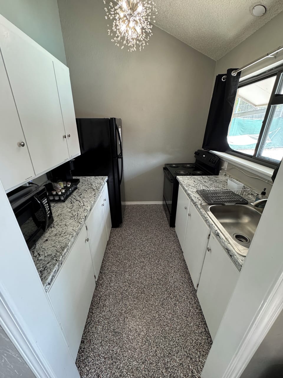 Full kitchen with full-sized fridge