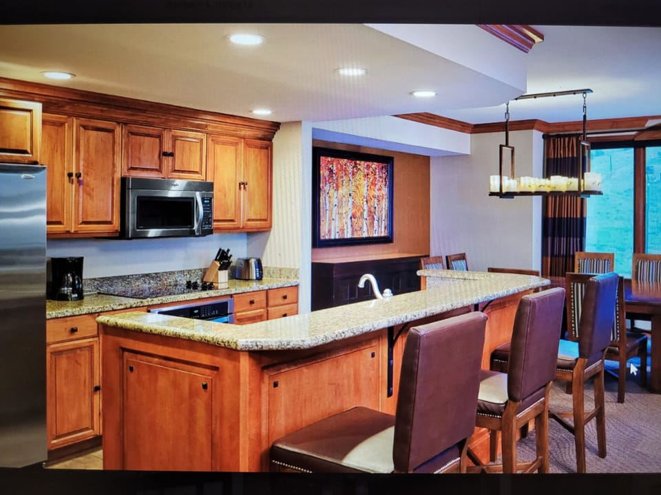 Full kitchen area with kitchen bar area with seating and separate dining space 