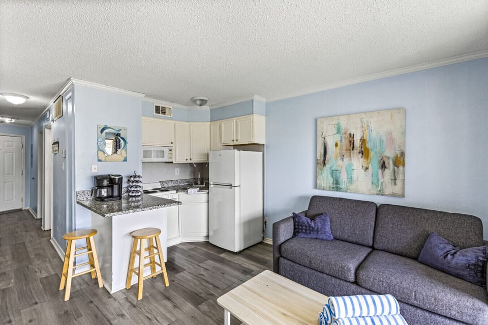 Open kitchen and living area with modern decor and cozy seating.