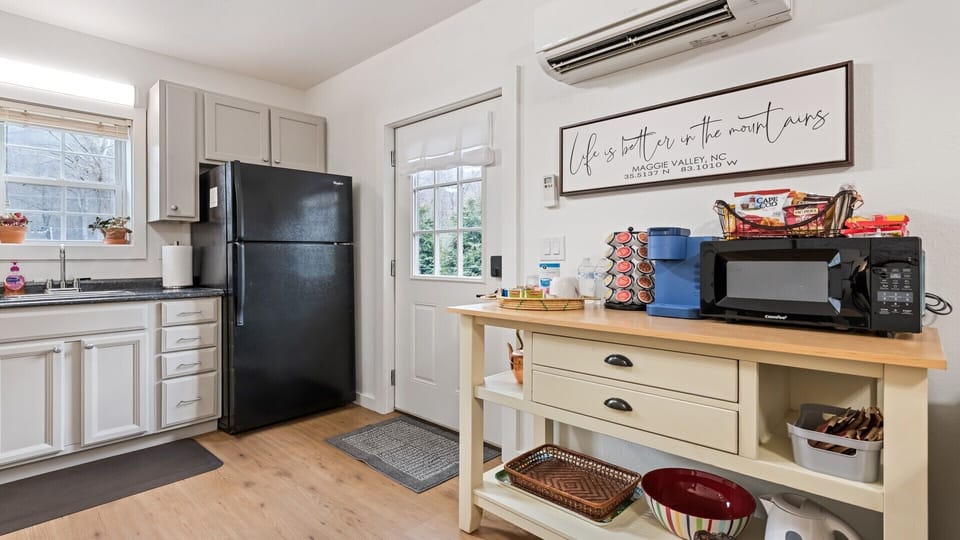 Coffee bar with Keurig, French press, microwave, electric kettle, & rice cooker.