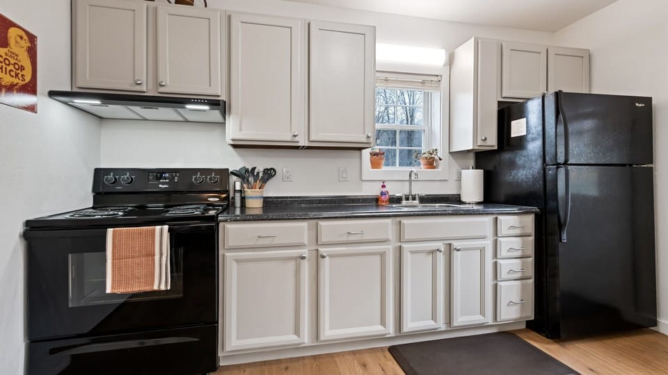 Kitchen with full size oven/stove and refrigerator.