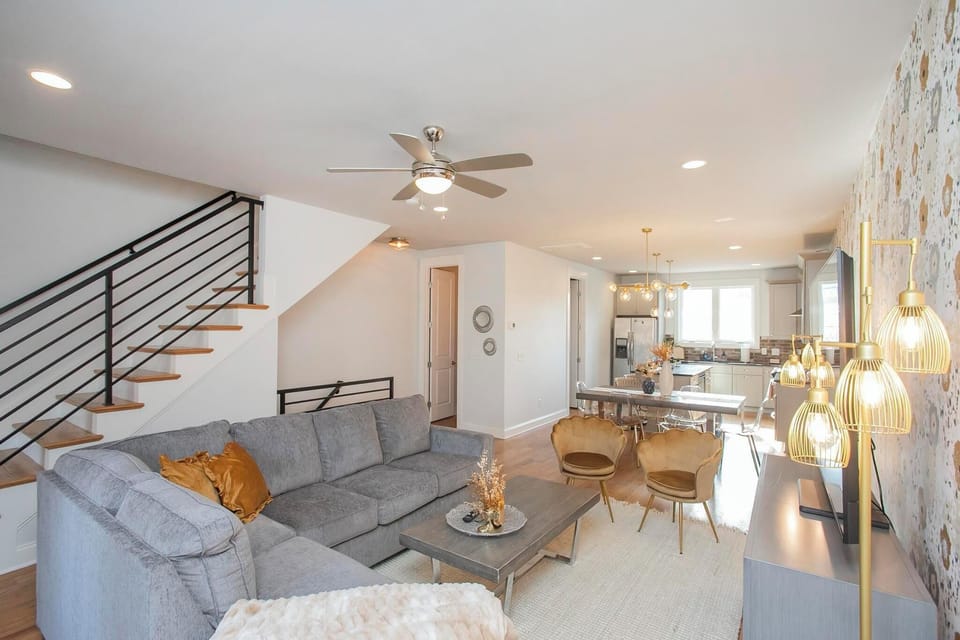 Living room on second floor with plenty of seating and a 65 inch smart TV