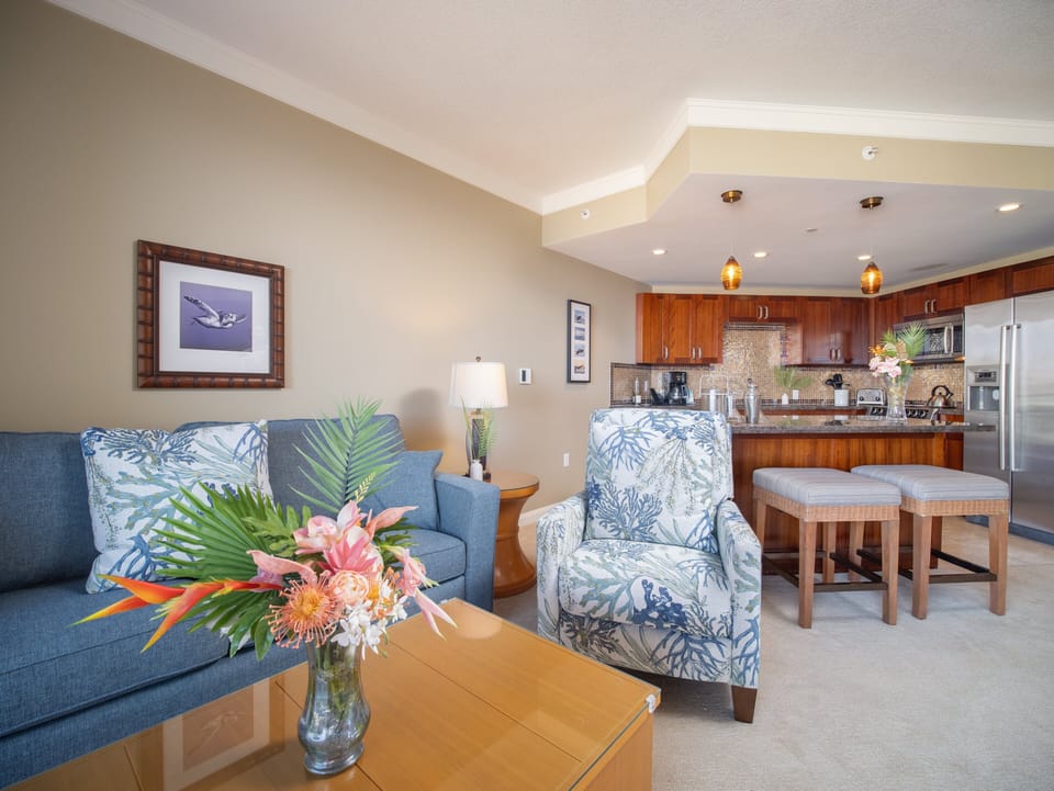 Relax in the spacious living area with vibrant coastal accents, just steps from the fully equipped kitchen.