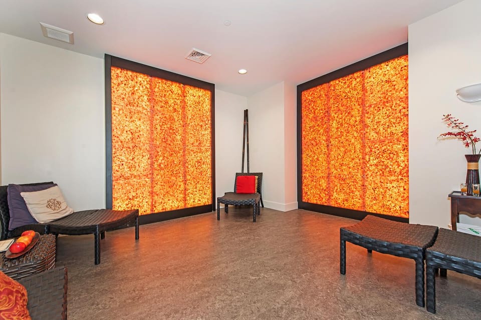 Unwind in the peaceful spa lounge featuring soothing light panels, designed to enhance your relaxation experience at Honua Kai's renowned spa.