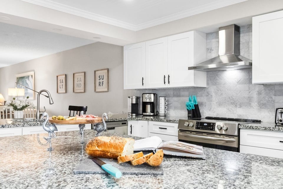 Fully equipped kitchen with granite countertops and modern appliances.