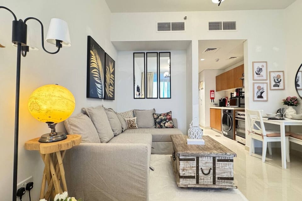 A thoughtfully crafted living area, blending comfort and functionality with a cozy sofa and bed.
