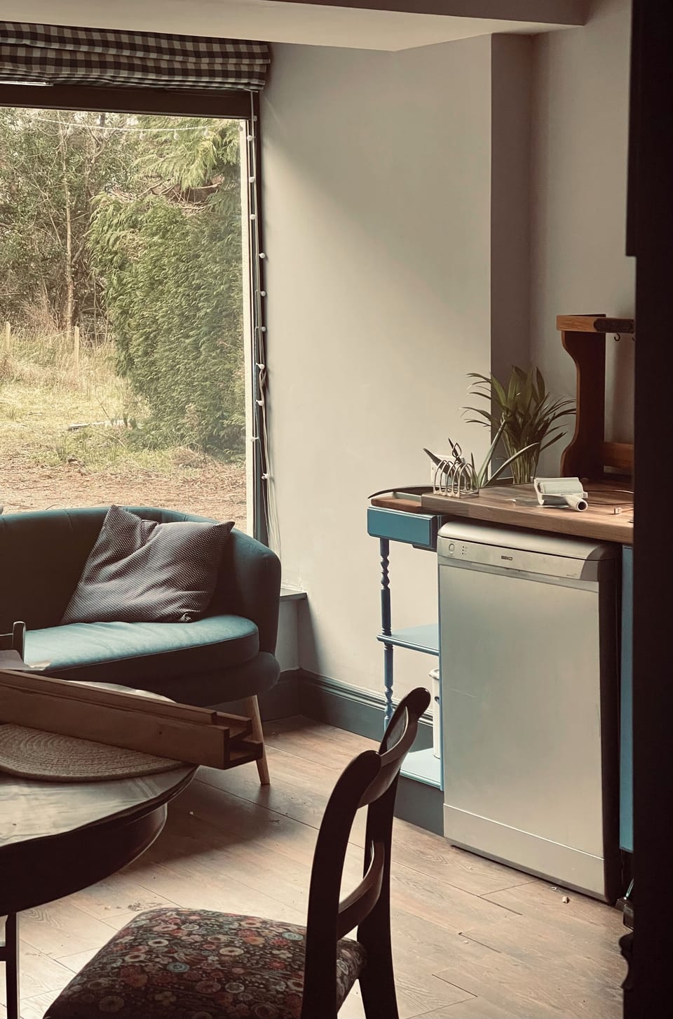 The kitchen's floor-to-ceiling window floods it with light all day long.
