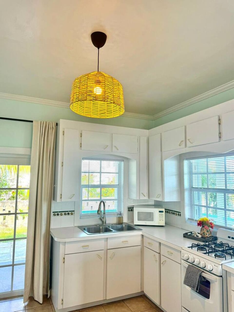 A sunlit, fully equipped kitchen where island flavors shine and every meal becomes a creation.