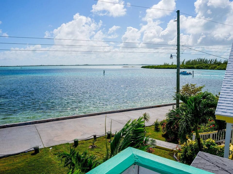 Panoramic ocean views await on the upstairs porch — the perfect place to unwind, breathe deeply, and savor the island.