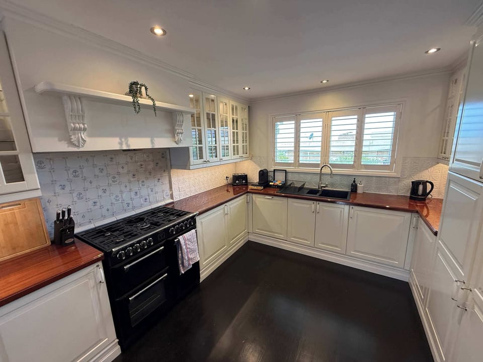 Fully-equipped kitchen with ample kitchenware and white goods