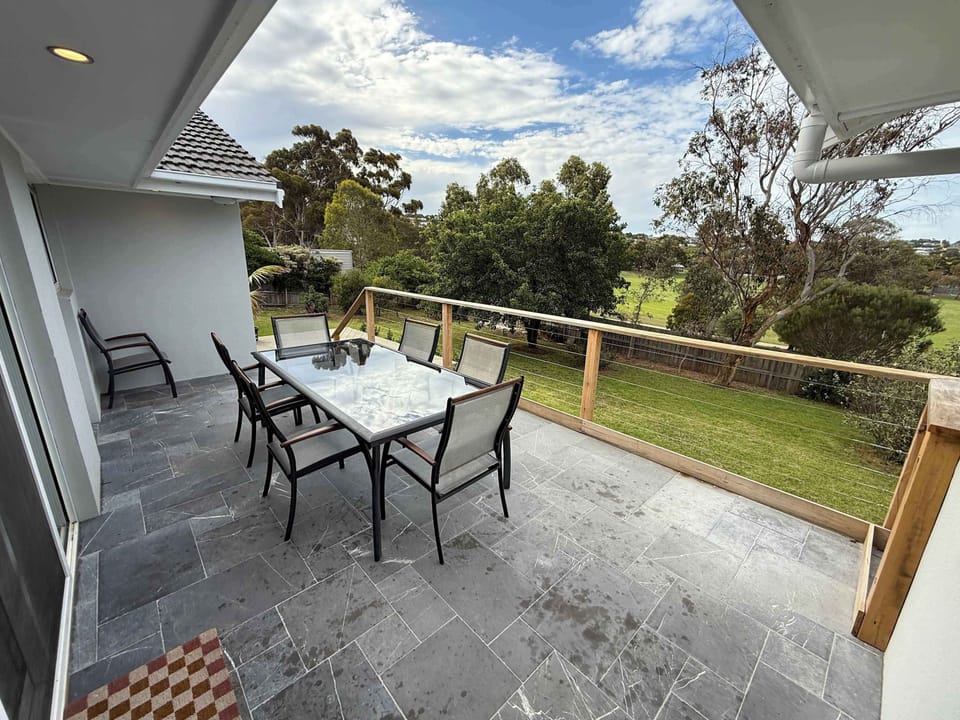 Expansive backyard featuring deck and outdoor furniture
