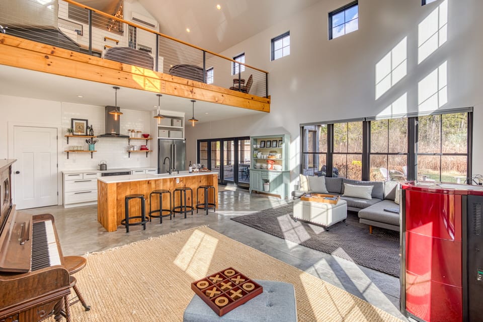 View from the corner of the living room into the kitchen, and up to the loft