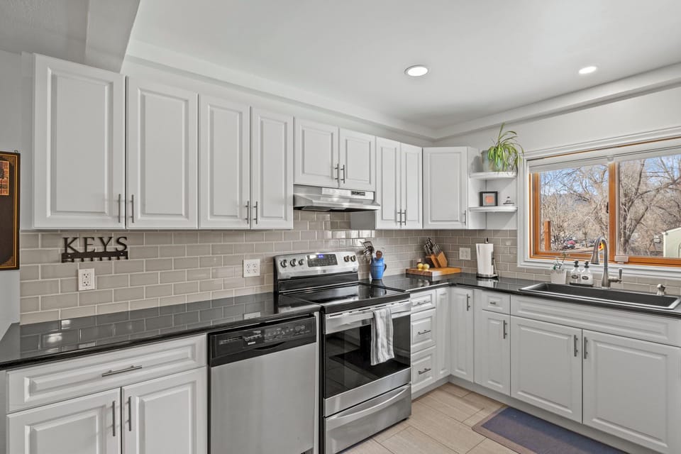 Kitchen with dishwasher, oven, and stove
