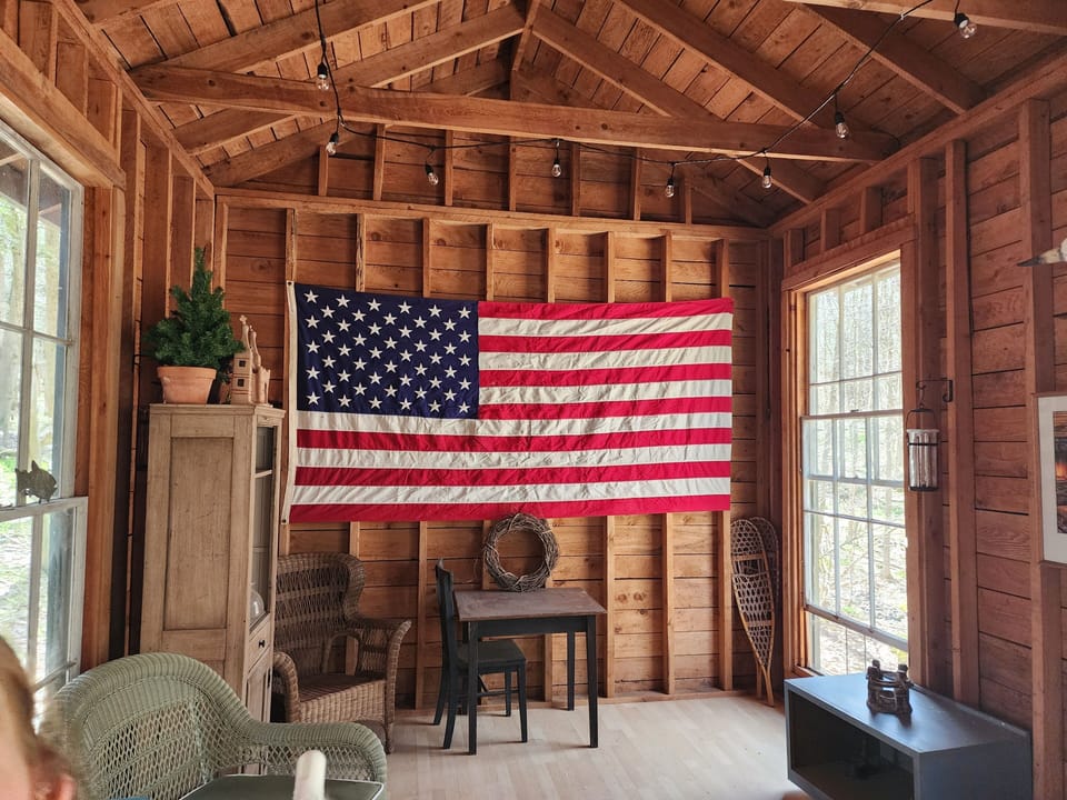 Out back, your cabin and firepit await—classic American woods retreat.