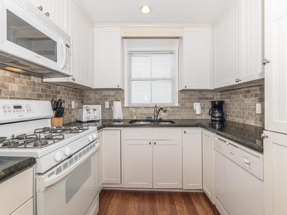 Cook up family favorites in the modern open-concept kitchen with sleek appliances and ample counter space.