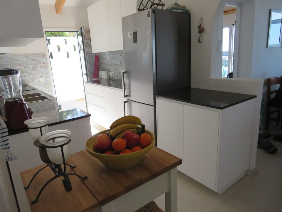 Kitchen with ample work spaces +Oven, Microwave, kettle, toaster + coffee maker